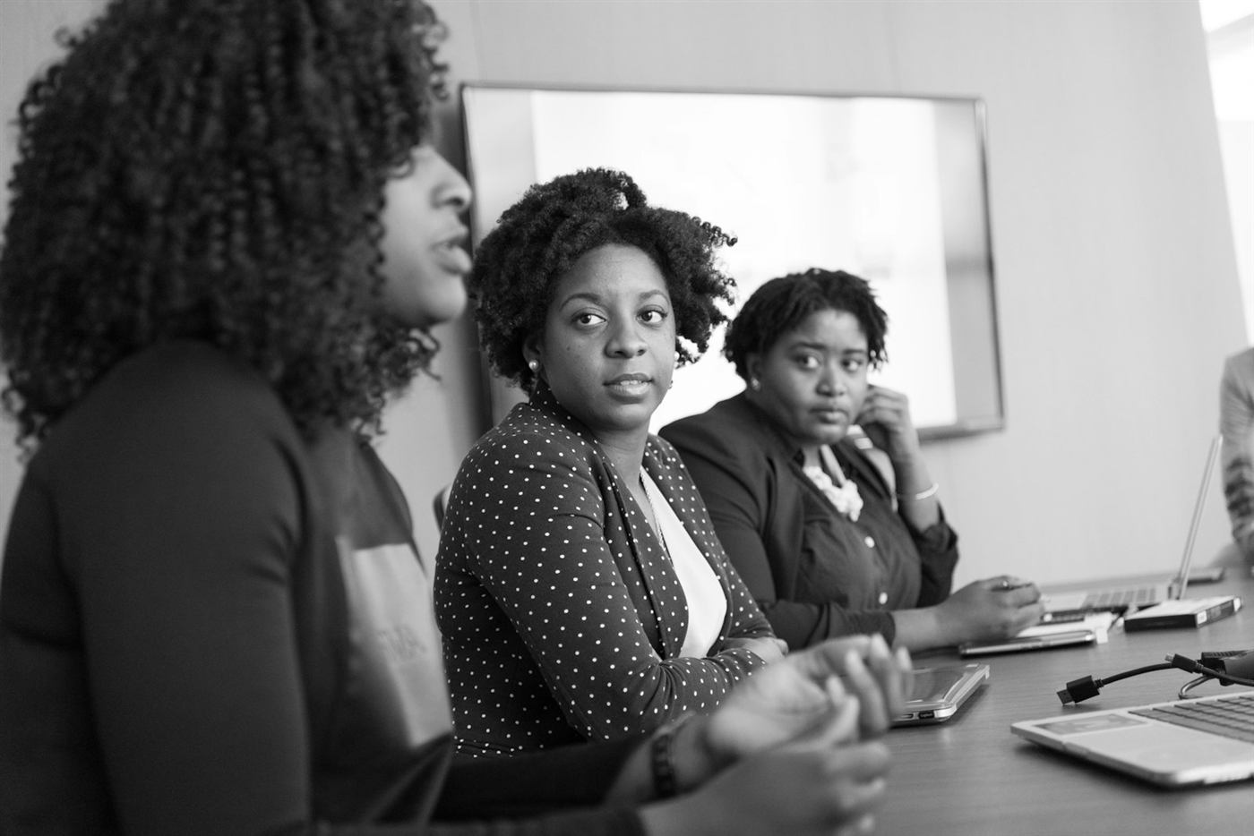 A team of colleagues talking around a meeting table